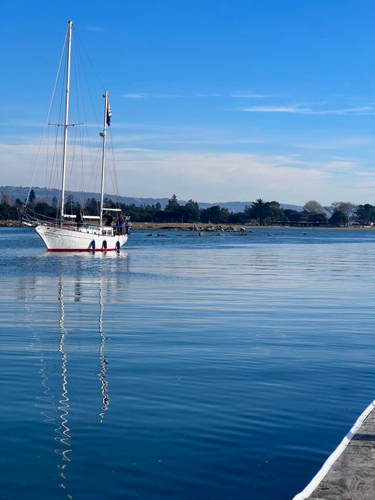Ketch at anchor with a mirror reflection